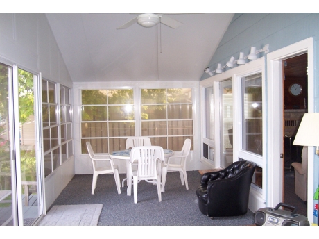 Partial view of sun room surrounded by windows