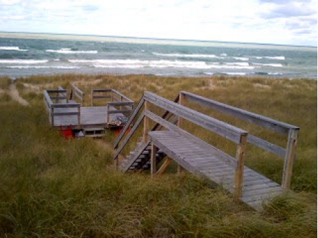 Stairs to the beach with a sunset deck