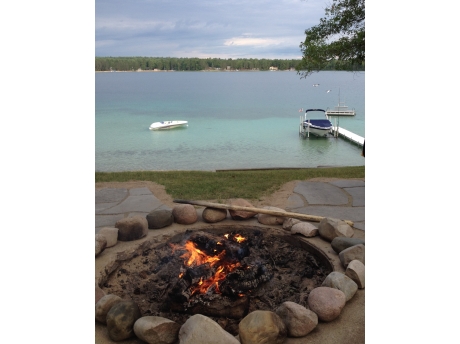 Bonfire pit and a view of your boat moored on the lake.