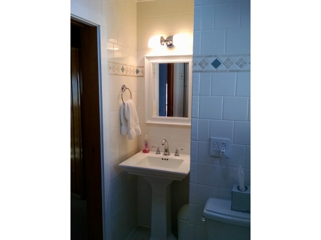 Cute, clean bathroom with a skylight