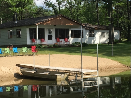 View of beach/dock/boat from lake.