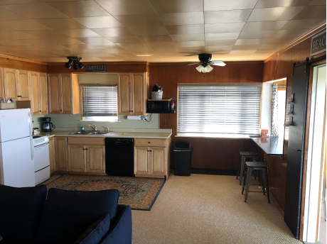 Open kitchen area with bar and table seating