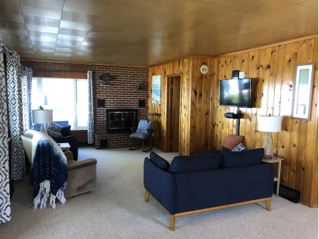 Cozy living area in knotty pine gives an original vibe